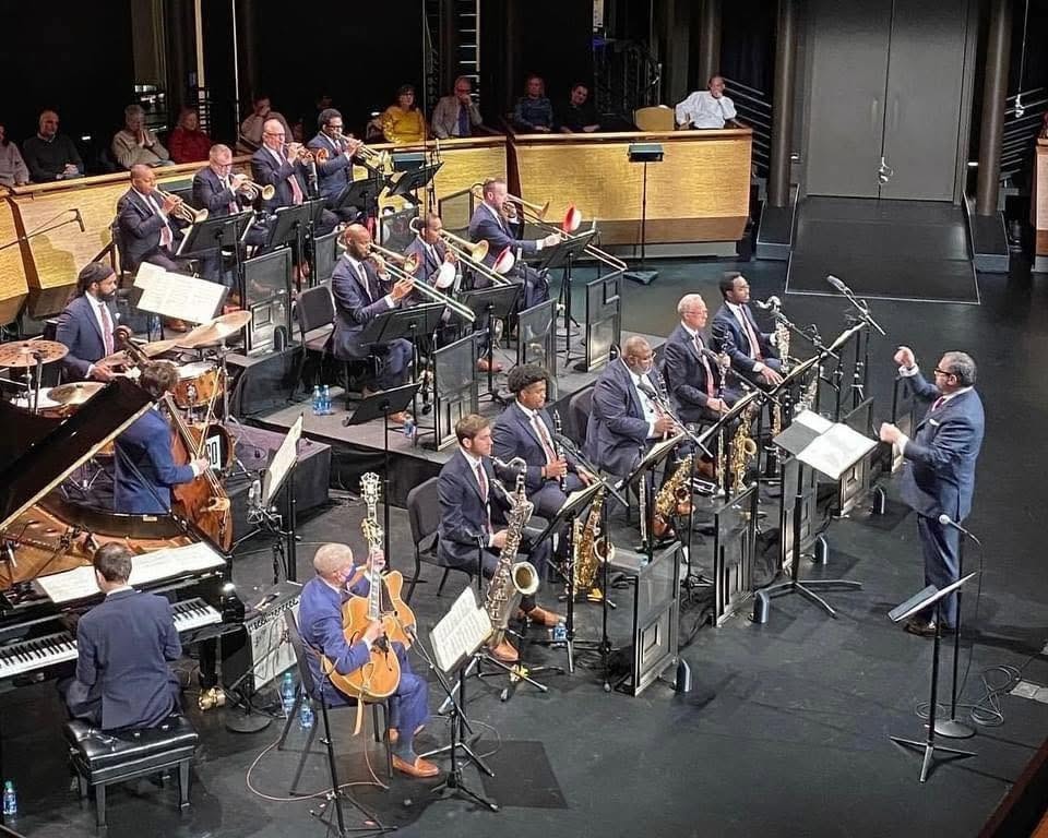 Andy Farber conducting a full jazz orchestra on stage